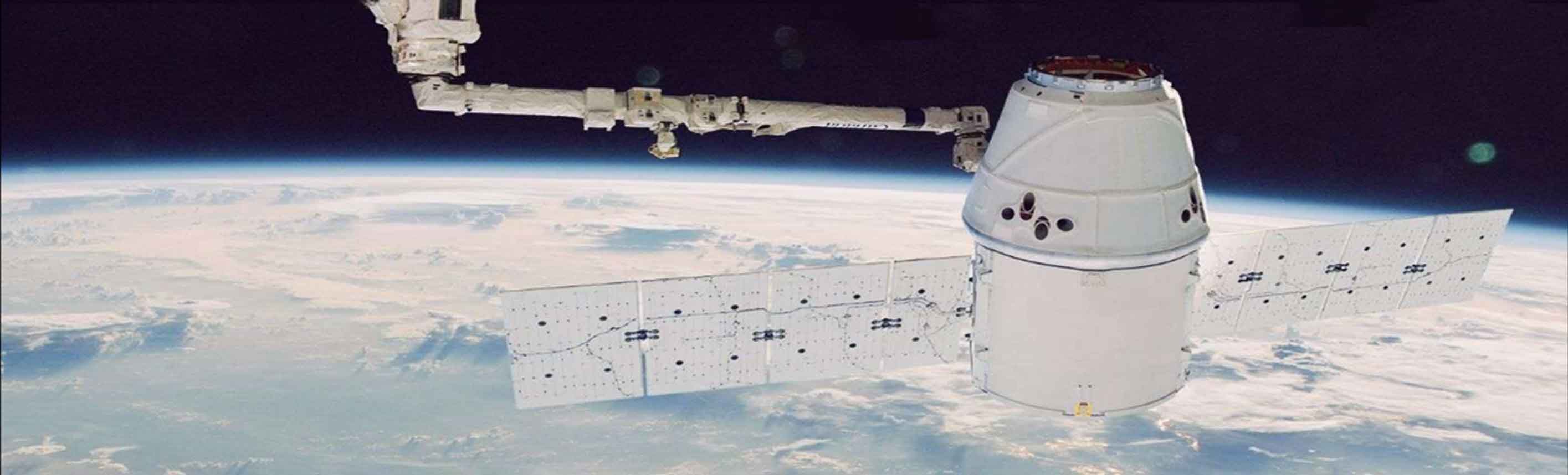 Image of space craft orbiting the earth with solar panels